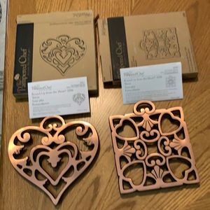 Two brass colored trivets
